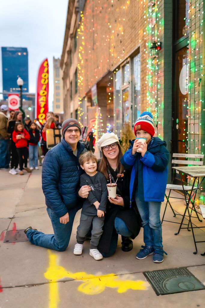 a family enjoying hot chocolate at lights on broadway 