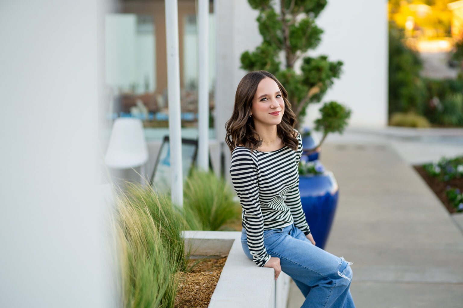 Senior girl posing and sitting down in Urban Photo Session Oklahoma City Paseo for Missy Mayo Photography