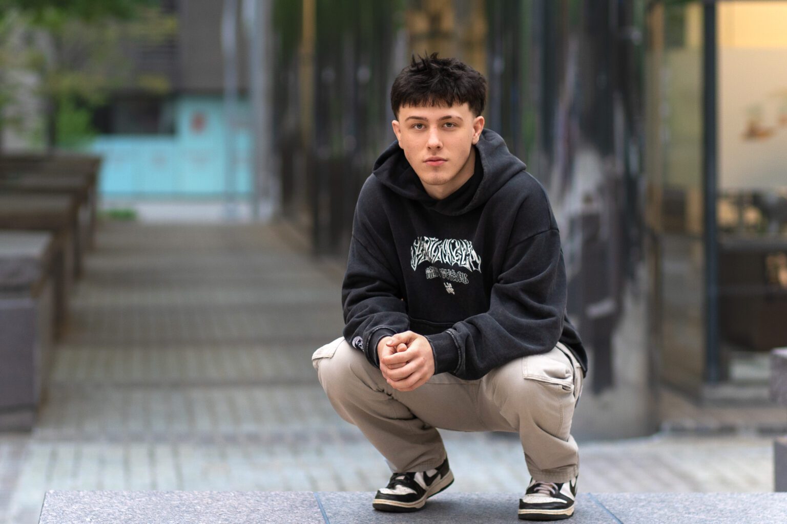 Senior Guy posing and sitting down in Urban Photo Session Oklahoma city for Missy Mayo Photography