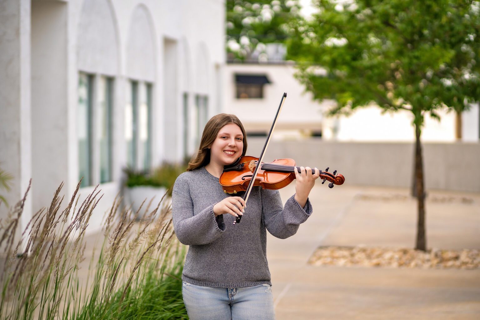 Senior girl playing the violin in Urban Photo Session Oklahoma City for Missy Mayo Photography