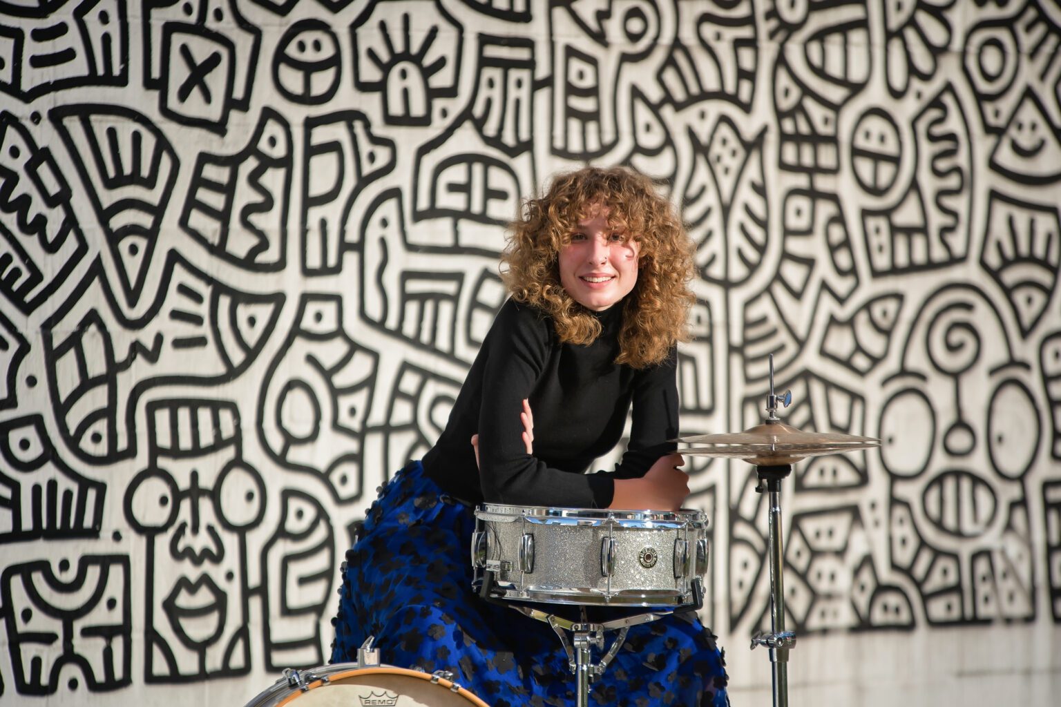 Senior portrait props idea: a graduating senior playing a snare drum, a fun music-themed prop for photos