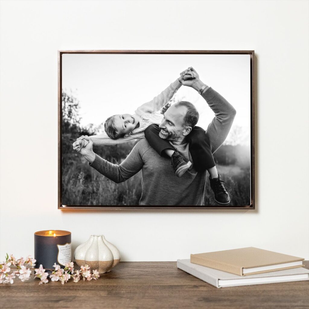 Black and white father and child portrait in a float frame on a cozy shelf, a photo gift idea from an Oklahoma City family photographer